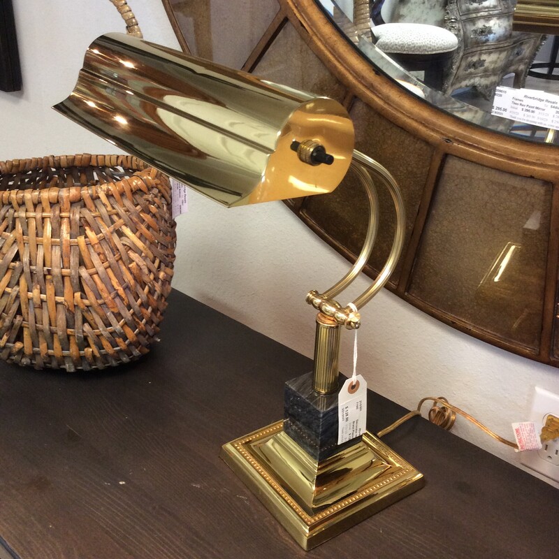 This piano/desk lamp has a high polish brass finish and is mounted on a block of black marble.