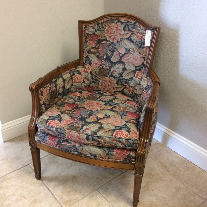 This sweet, petite side chair has been upholstered in a brightly colored floral pattern. The frame has a dark wood finish and features lovely carved details.