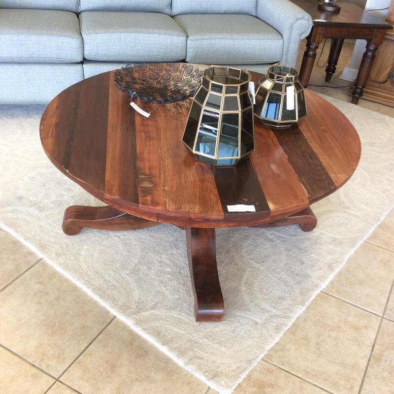 This is a beautiful hand-made coffee table. This coffee table has 3 different woods such as Redwood, Oak and Mapel. It stands high so you would want to have a taller sofa.