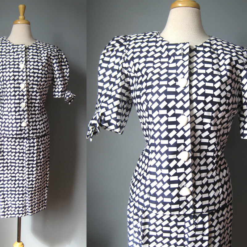 Channel Alexis Carrington in this high quality 1980s power suit.
It has a strong silhouette with big shoulder pads and short puffy sleeves with bows on the ends.
Nipped at the waist and the skirt is tight and a bit short.
made in the USA

Made of fine cotton twill in a navy and white abstract print.


SIZE INFO: Marked size 6 but pls rely on the measurements below
Jacket:  very nicely tailored , fully lined
flat measurements:
shoulder to shoulder: 14.25
armpit to armpit: 18
wasit: 16.75
length: 22.5

Pencil skirt: The skirt closes with a button, it's unlined and has elastic across the back of the waist band, also Pockets
flat measurements:
waist: 13
hip: 20
length: 24.5

The hem turn is 2 so you could have it made up to about 1.5 longer if desired.

Both pieces in perfect condition, they appear to have never been worn.


thanks for looking!
#45366