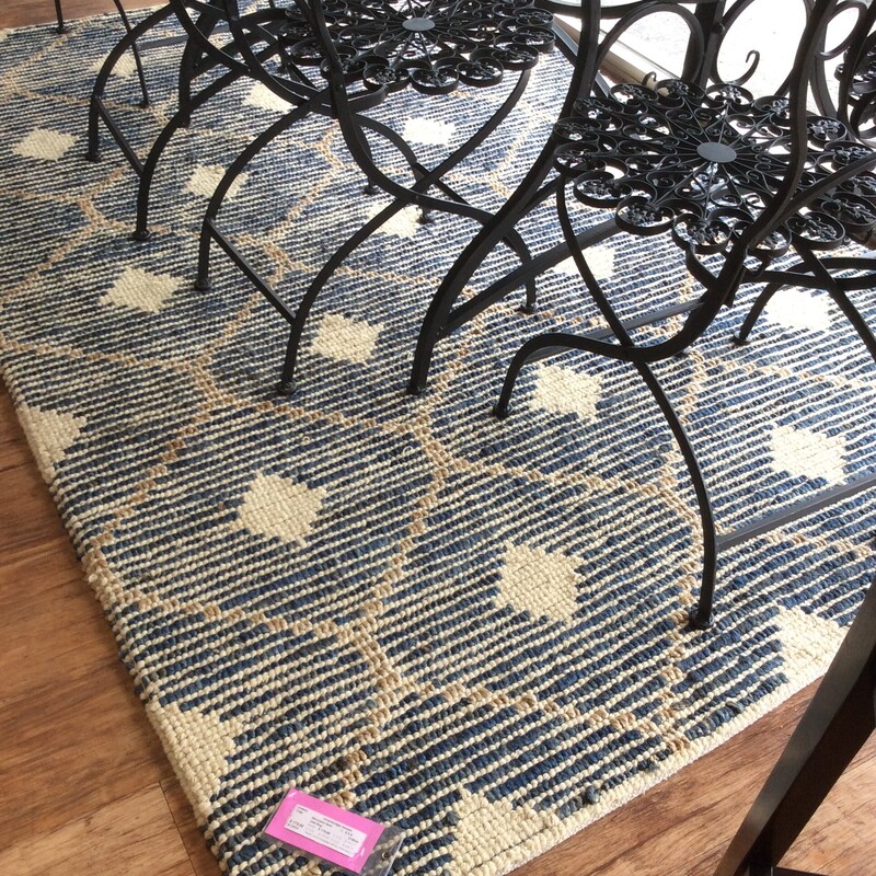 This 5 x 8 jute rug is woven with a simple geometric design in Navy, cream, and natural jute,