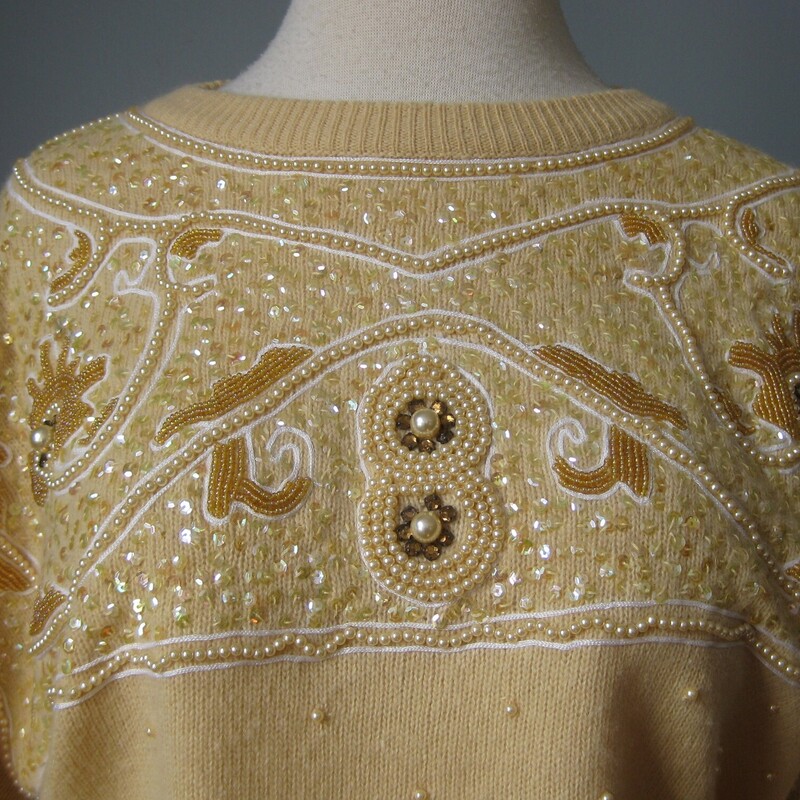This glamorous vintage sweater is by Vyana White.   It's made of angora wool blended with lambswool and nylon (for durability)<br />
The upper chest is covered with nice pearls, sequns and beads in a baroque pattern.<br />
Marked size XL<br />
Flat measurements:<br />
Shoulder to shoulder: 23<br />
Armpit to armpit: 23<br />
Underarm sleeve seam: 20<br />
Width at hem: 17 unstretched, stretches comfortably to about 19.5<br />
Length 24.5<br />
<br />
Pefect condition<br />
<br />
Thanks for looking!<br />
#57551