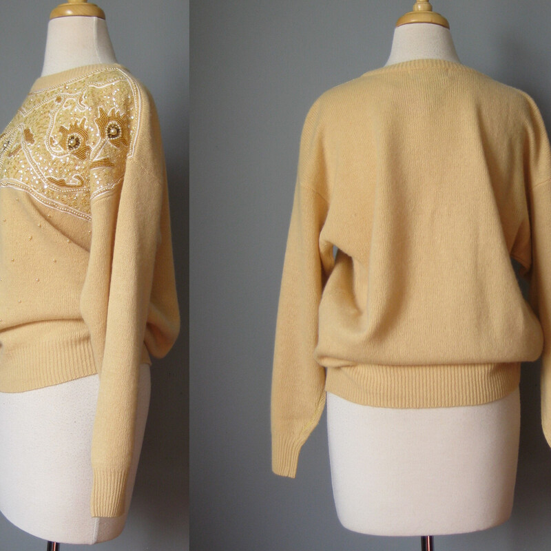 This glamorous vintage sweater is by Vyana White.   It's made of angora wool blended with lambswool and nylon (for durability)
The upper chest is covered with nice pearls, sequns and beads in a baroque pattern.
Marked size XL
Flat measurements:
Shoulder to shoulder: 23
Armpit to armpit: 23
Underarm sleeve seam: 20
Width at hem: 17 unstretched, stretches comfortably to about 19.5
Length 24.5

Pefect condition

Thanks for looking!
#57551