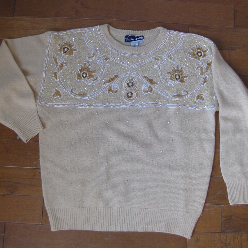 This glamorous vintage sweater is by Vyana White.   It's made of angora wool blended with lambswool and nylon (for durability)<br />
The upper chest is covered with nice pearls, sequns and beads in a baroque pattern.<br />
Marked size XL<br />
Flat measurements:<br />
Shoulder to shoulder: 23<br />
Armpit to armpit: 23<br />
Underarm sleeve seam: 20<br />
Width at hem: 17 unstretched, stretches comfortably to about 19.5<br />
Length 24.5<br />
<br />
Pefect condition<br />
<br />
Thanks for looking!<br />
#57551