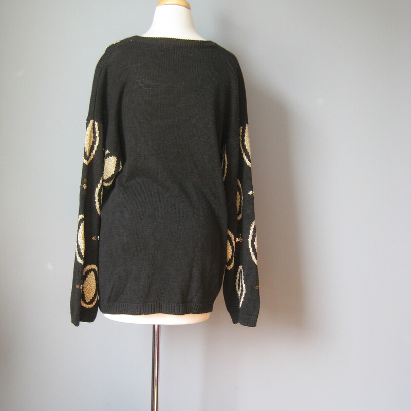 Gorgeous oversize vintage sweater in Black with a gold and clear plastic jeweled medallion pattern.<br />
55% Ramie and 45% cotton<br />
Marked size Medium but will fit a size large as well<br />
Flat Measurements:<br />
Shoulder to shoulder: 25.5<br />
Armpit to Armpit: 22.75<br />
Underarm sleeve seam length: 21<br />
Length from back neck to hem: 27.25<br />
width at hem unstretched: 22<br />
<br />
Excellent condition!<br />
#43192