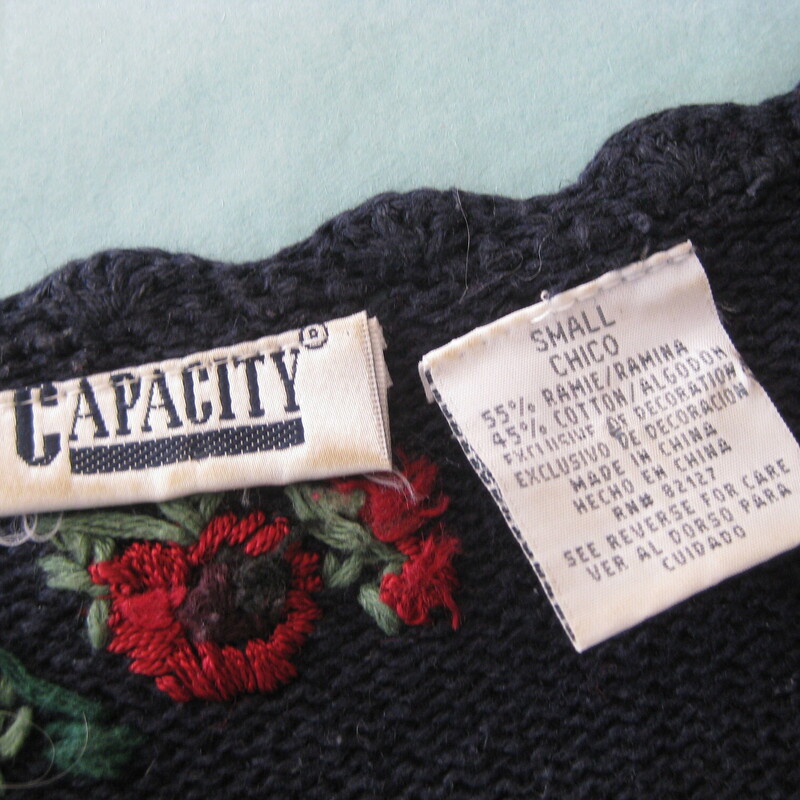 Vtg Capacity Roses, Navy/red, Size: Small<br />
<br />
Long cozy and girly navy blue sweater with happy red roses all over the front.<br />
It also has open work edges embellished with velvet ribbon.<br />
<br />
by Capacity made of a cotton ramie blend.<br />
<br />
Marked size S<br />
flat measurements:<br />
Shoulder to shoulder seam: 16.5<br />
armpit to armpit: 19.5<br />
width at hem: 21<br />
length: 26.75<br />
underarm sleeve seams: 19<br />
<br />
thanks for looking!<br />
#57760
