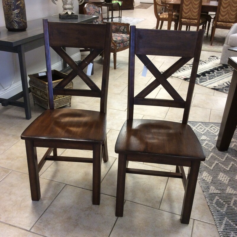 This set of 4 dining chairs are made of solid wood with a cross back design and a dark stained finish.