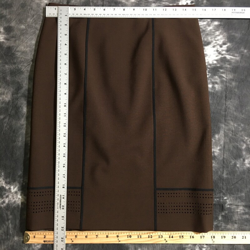 100-1094 Worth, Brown, Size: 4 brown skirt with black lines and square holes on the bottom 95% wool 5% elastane  good