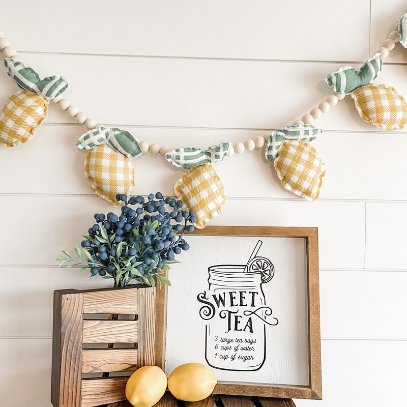 Hand-stitched lemon garland with wood beads and jute hanger. Measures approximately 48' in length.