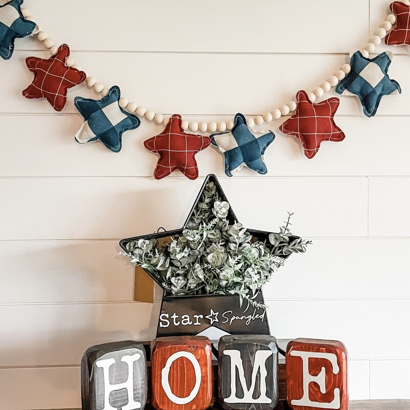 Patriotic hand-stitched flannel plush star garland on jute twine with wood bead accents. Measures approximately 48' in length.