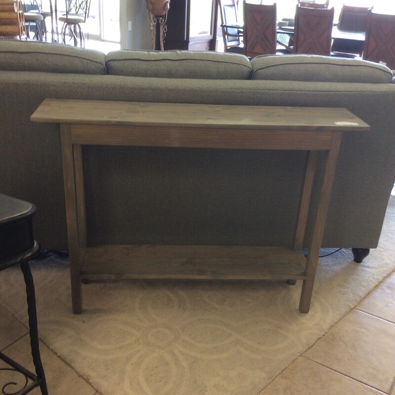 This sleek design entry table has a black wood base and a rustic biege stained top.