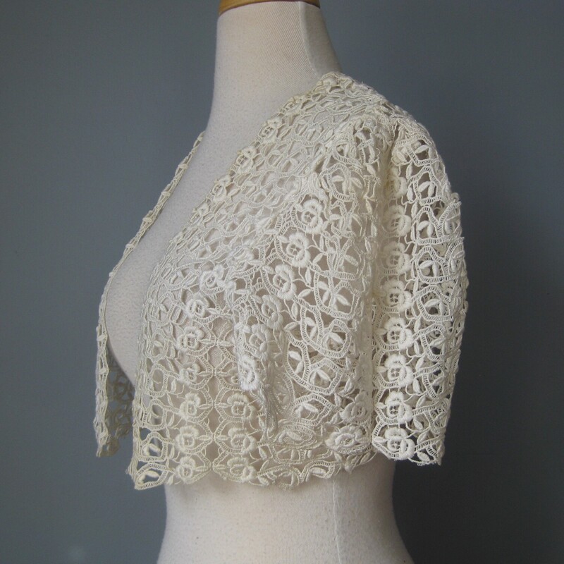 Antique Crochet Shrug, White, Size: None<br />
<br />
Antique crochet lace shrug in ivory<br />
Short Sleeves<br />
<br />
Great shape but a few things:<br />
faint brown areas at the back of the neck and at the front opening<br />
a small deeper rust stain along the bottom edge<br />
one bit of fraying at the bottom edge, I can fix for you before I ship, just remind me please! :)<br />
<br />
No tags.<br />
No closure.<br />
<br />
flat measurements:<br />
armpit to armpit: 18<br />
length back of neck to hem: about 11<br />
<br />
<br />
Thanks for looking!<br />
#57912