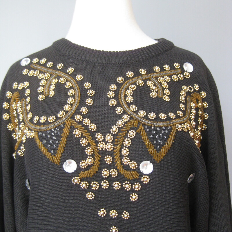 Gorgeous vintage sweater in Black with a scroll design done in coppery goldish beads and a few big jewels. By Lauren Allen<br />
55% Ramie and 45% cotton<br />
Marked size Large<br />
Flat Measurements:<br />
Armpit to Armpit: 23<br />
Underarm sleeve seam length: 20<br />
Length from back neck to hem: 26<br />
width at hem unstretched: 16<br />
<br />
Excellent condition!<br />
#43199