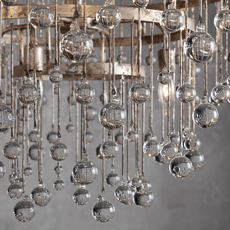 Arhaus Aubrey Chandelier<br />
Silver Metal with Clear Prisms Size: 36x41H<br />
Equally at home in an ancient French castle or a downtown New Orleans loft, this chandelier creates dramatic ambiance in any setting. Crystal drops hanging in varying lengths from an iron cage create the illusion of movement as they catch the light, refracting brilliant beams around your room.<br />
Retail $5349