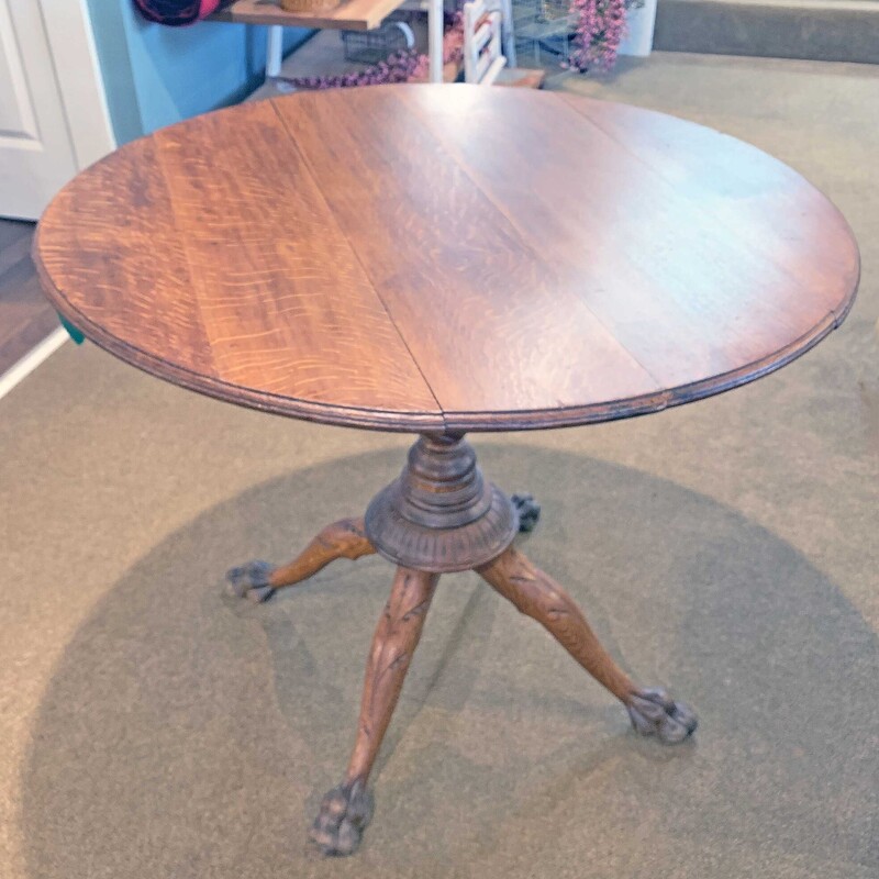 Antq Tilt Top Oak Table,
with Hand Carved Claw Feet & Legs
Size: 36in W x 30 in H
This is a beautiful table - excellent condition with
great character.
