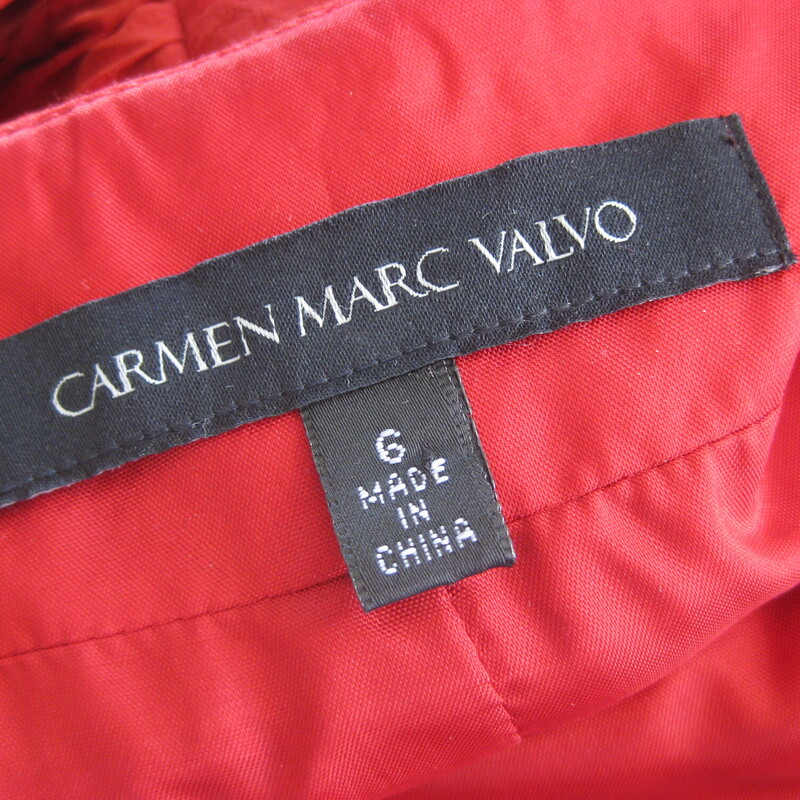Carmen Valvo Silk Bandge, Red, Size: 6<br />
You will have them in the palm of your hand whether you are coming or going in this killer designer cocktail dress in deep red silk.<br />
It's tight<br />
It's FLIRTING with 'too much' in terms of skin showing but it's definitely on the right side of the line<br />
<br />
Beause it's not shiny (the silk is matte) or bright (the red is deep, almost brick red with no brown in it) or too short (probably below the knee on most women) and it's so beautifully executed that it gives luxe, daring but not tacky.<br />
So pour yourself in, stand up straight and work it!<br />
<br />
By Carmen Marc Valvo<br />
<br />
100% silk.<br />
Fully lined<br />
NO stretch.<br />
The bodice has a bit of boning<br />
Center back zipper<br />
<br />
Marked size 6, but might fit smaller at the bust<br />
Armpit to armpit: 17.75<br />
Waist: 14.75<br />
Hip: 18.5<br />
Length: 39<br />
<br />
Like new condition.<br />
<br />
Thanks for looking!<br />
#54808