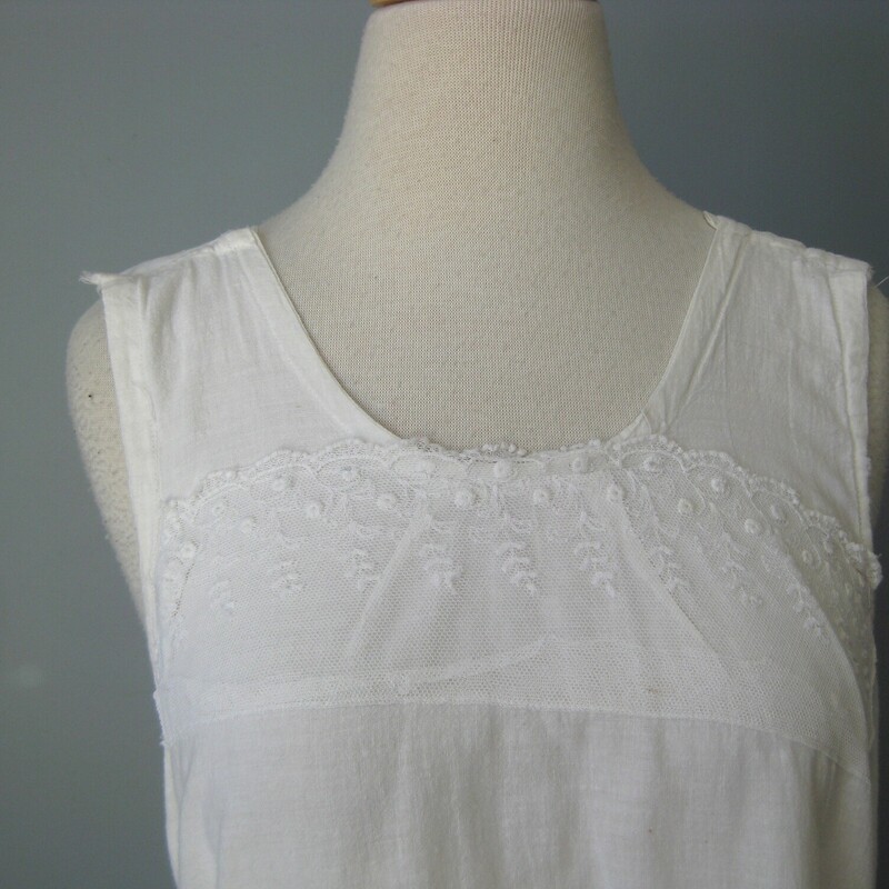 Edwardian Cotton Chemise, White, Size: Small<br />
Period Edwardian Cotton chemise, orginally intended as a under garment layer.<br />
Made of lightweight cotton it's very simple with a panel of fancy netting across the uppder chest.<br />
This shoulder straps have been folder and sewn so if you wish for it to sit lower on the chest you could easily release that stitching for an extra inch or so of length there.<br />
No closure<br />
 The woven cotton fabric is soft and lightweight, in excellent condition with a very few minor and tiny spots as shown.<br />
One of the side seams needs a few stitches, I can do this repair before I ship it if you like, just please remind me.<br />
<br />
Here are the flat measurments:<br />
<br />
armpit to armpit: 18<br />
across the waist area: about 20<br />
hips: about 23<br />
length: 35.5<br />
<br />
I am not an expert in this period but certainly appreciate it very much.  If you have any info to share about this piece please don't hesitate to message me.  I would be very grateful!  I have a couple more of these dresses and a few cropped shirts to share soon so please visit again!<br />
<br />
Thanks for looking!<br />
#53846