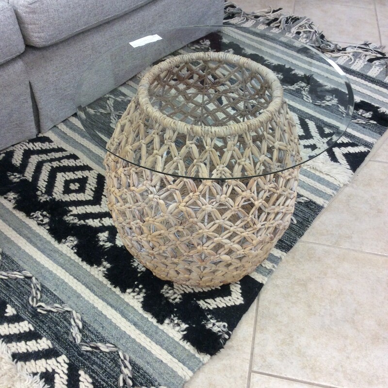 This is a beautiful nautical wicker side table with a round glass top.