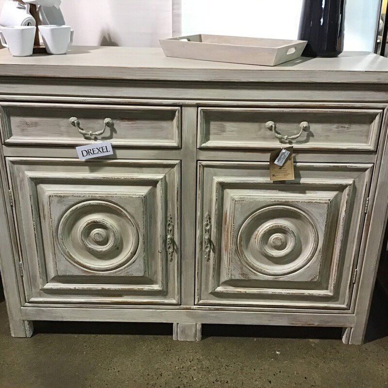 Drexel Furniture
Driftwood washed color
1 felt lined drawer
1 divided drawer
Decorative circle fronted doors
2 door with inner shelf
THIS PIECE IS HEAVY

Dimensions: 58x21x43