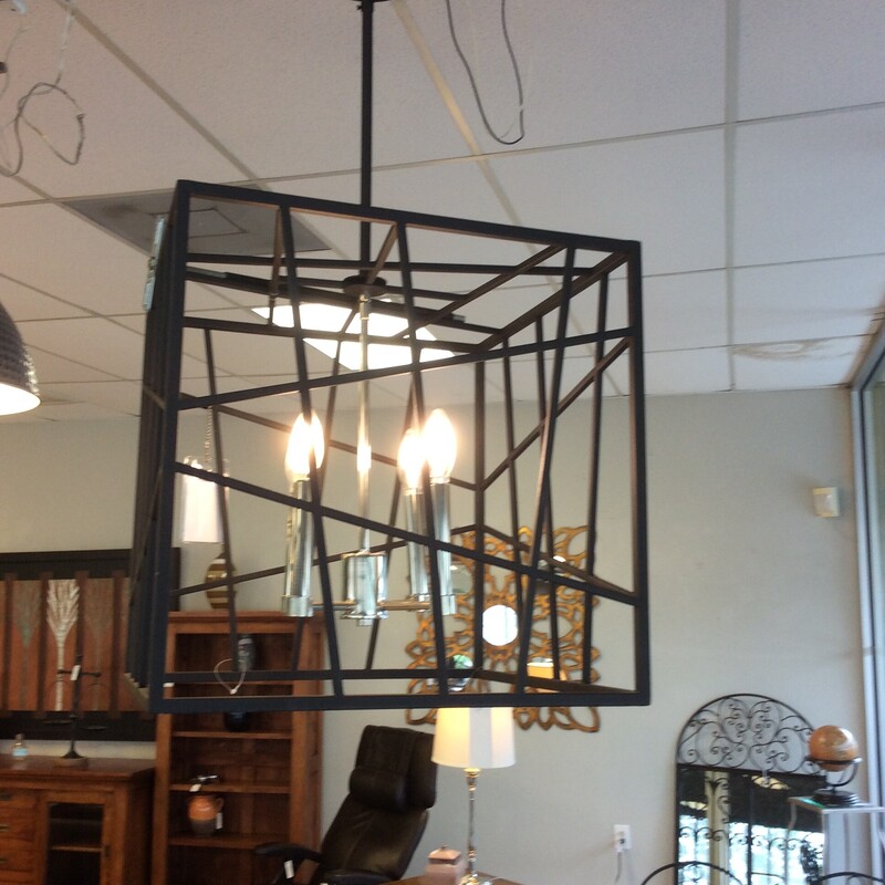 This contemporary style pendant light has an open cube shaped shade that surrounds 4 chrome candlestick lights.