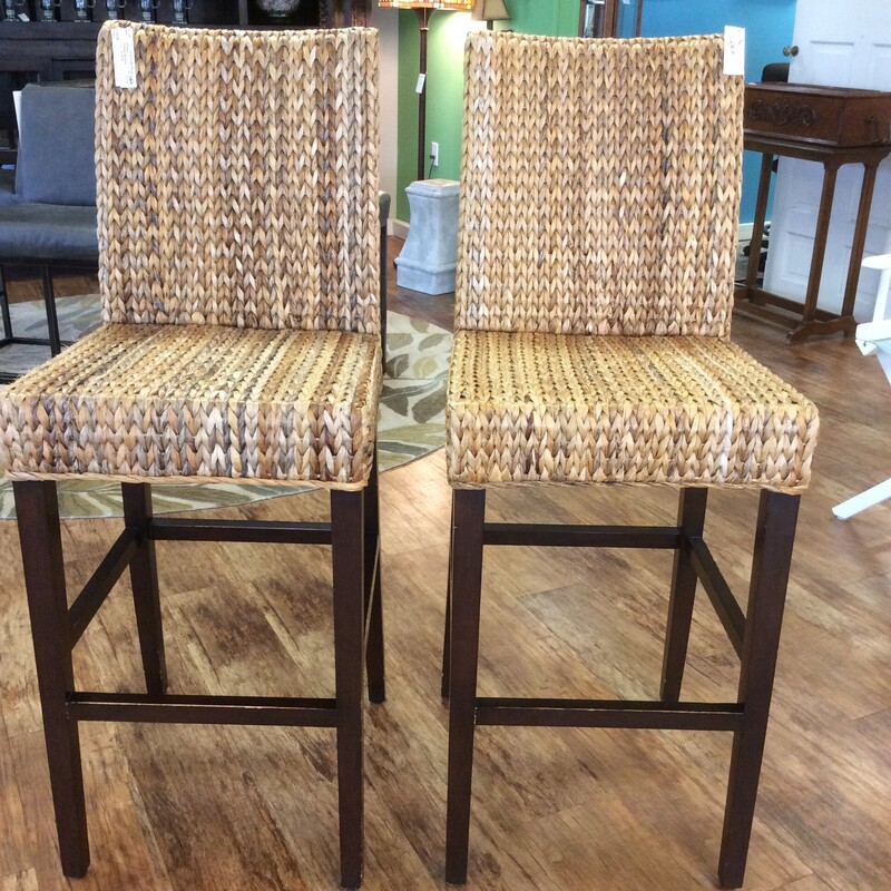 This pair of barstools have a wood frames with  woven rattan seast and backs.