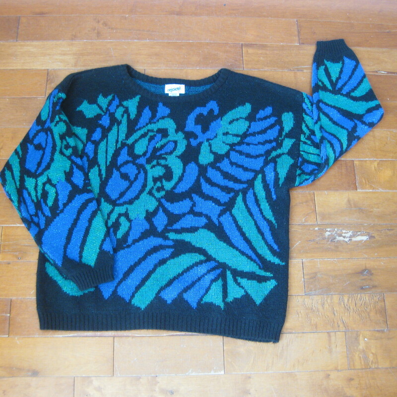Here's a cute easy sweater in royal blue green and black yarns with a generous amount of metallic threads twisted into the yarn. Acrylic, nylone and metallic blend with long sleeves, dropped shoulders and relaxed fit.<br />
<br />
No size tag. Should fit modern medium to large<br />
<br />
Excellent condition<br />
<br />
Flat measurements, please double where appropriate:<br />
<br />
shoulder to shoulder: 25.5 The shoulder seams are 'dropped' meaning that they sit somewhere along the upper arm, not at the shoulder 'point'<br />
Armpit to armpit: 24<br />
waist: 21.5 no stretch or snap here<br />
Underarm sleeve seam length: 19<br />
length: 24<br />
<br />
thanks for looking.<br />
#45616