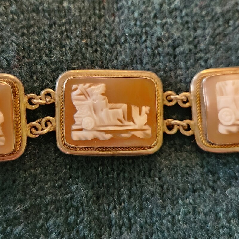 AMAZING CONDITION    .8 oz
Antique Edwardian SHELL CAMEO Bracelet and Sterling 925 depicting ROMAN life - chariot racers (circa 1901 - 1910)
Seven hand-carved shell cameos, each representing a day of the week, with a chariot driven by respective gods and goddesses, including: Mars, Mercury, Zeus, Aphrodite, Saturn, each being conveyed by different means - from left to right: A slave, two horses, two chickens, two birds on land, two birds in flight, one or two dragons and a team of four horses