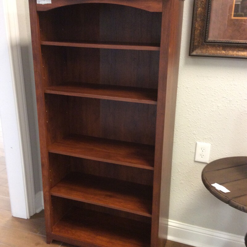 This is a very nice cherry colored, 5 shelf book case. This book case has 3 adjustable shelfs.