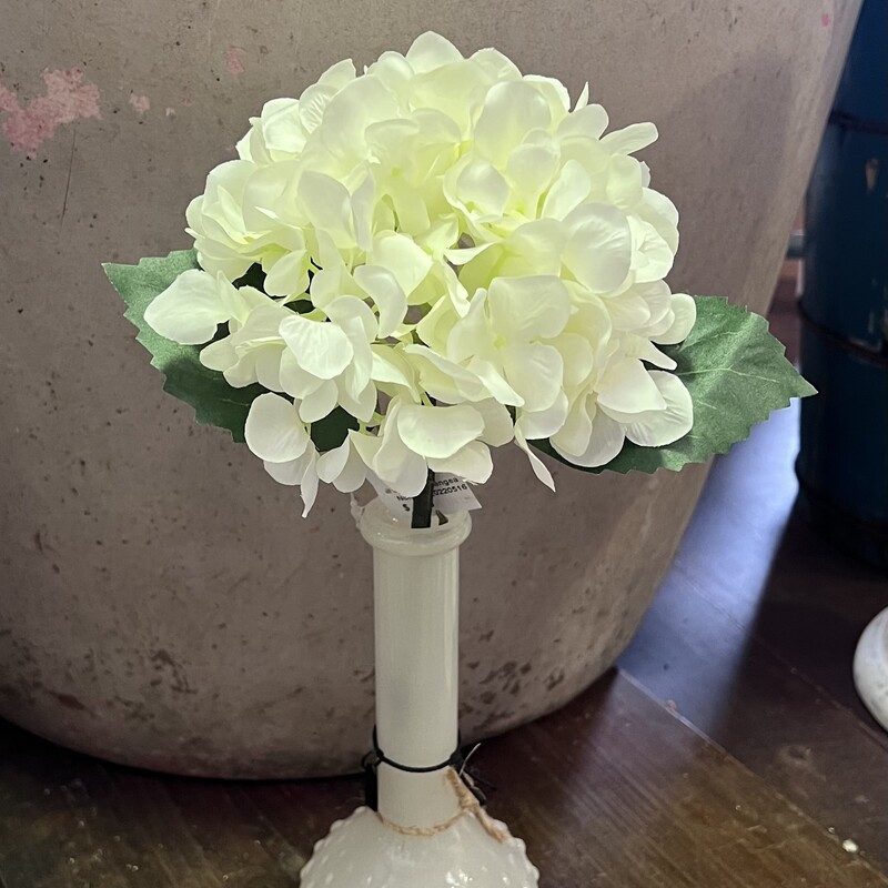 This pretty white hydrangea has fabric petals and leaves with a plastic stem.  Hydrangea measures 13 inches tall and looks beautiful alone in any vase or grouped with any  floral arrangement