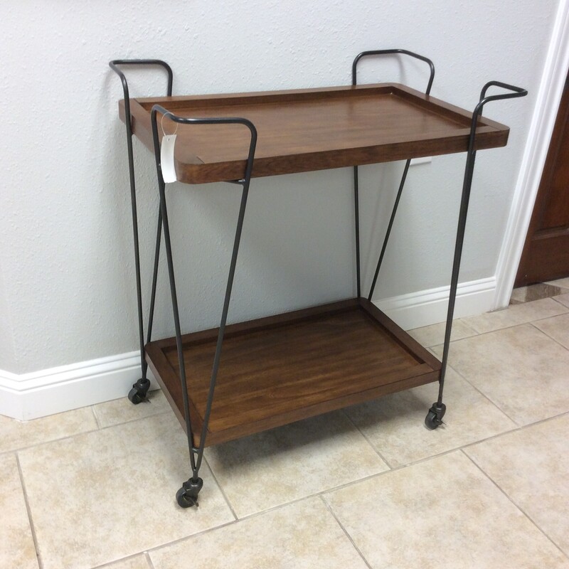 This is a very nice Ashley wood and metal bar cart. This bar cart has 2 trays and is on wheels for better mobility.