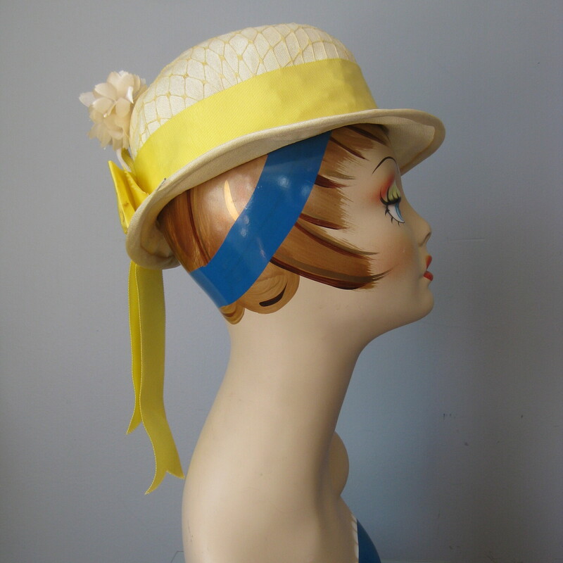 Sweet little summer hat in organza and ribbon.
Wide brim with a wide yellow ribbon and a white fabric flower

Union label
Made in the USA
Condition:  Good shape but old, some grime. The wire around the outer edge of the rim is beginning to poke through, as shown.

Quite Small!
Inner hat band measures 2.75 inches around


Thanks for looking!
#1874