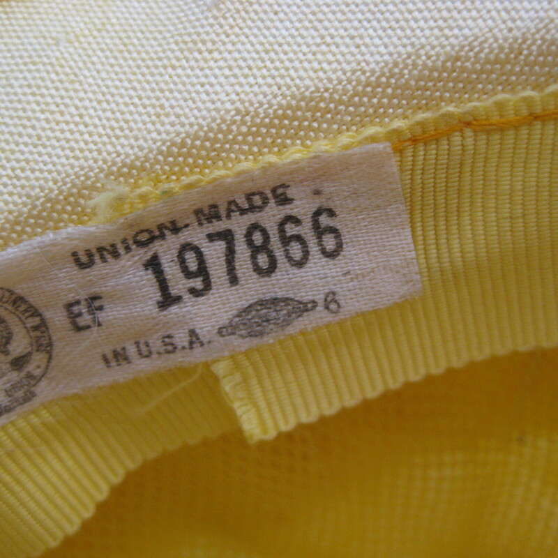 Sweet little summer hat in organza and ribbon.
Wide brim with a wide yellow ribbon and a white fabric flower

Union label
Made in the USA
Condition:  Good shape but old, some grime. The wire around the outer edge of the rim is beginning to poke through, as shown.

Quite Small!
Inner hat band measures 2.75 inches around


Thanks for looking!
#1874