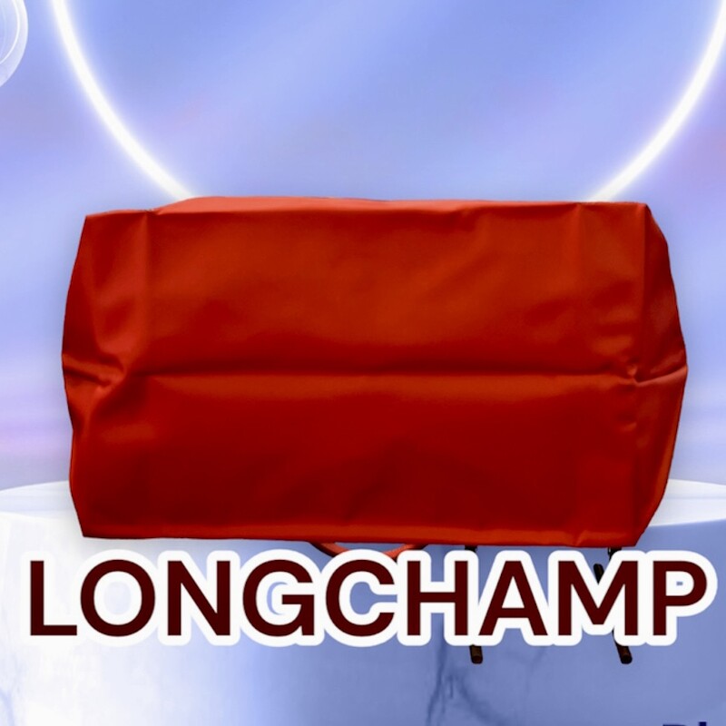 LONGCHAMP
Le Pliage Tote
Original Retail: $155.00

Smooth, sleek red nylon and embossed leather trim make this spacious tote a no-brainer for everyday versatility and elegance.
This bag is preowned, in like new conditions.  Does not appear to ever of been used.  Spotless interior and exterior.
Water-resistant lining
Textile with leather trim
12 1/4”W x 11 3/4”H x 7 1/2”D.
9\" Strap Drop
*******In 1948, Jean Cassegrain turned his Paris tobacco shop—where he was known to cover his pipes in an exquisite leather—into an accessories business. Named after the famed horse track on the outskirts of Paris, Longchamp is still family owned and operated, creating superbly crafted handbags and luggage lauded for a decidedly understated, always chic look.