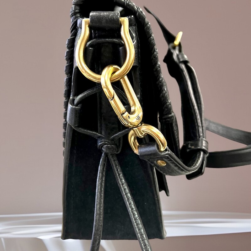 Stuart Weitzman<br />
<br />
PETITE LOLA' WHIPSTITCH EDGE LEATHER BAG<br />
Melding the best features of two coveted styles from Stuart Weitzman, this Petite Lola bag features an envelope-inspired structure hand-laced with whipstitched edges. Cinched with corset-inspired lacing at the side, this holdall features an optional shoulder strap that can be slung over the shoulder or carried as a clutch.<br />
<br />
-Black grainy leather<br />
-Hand-laced whipstitching<br />
-Detachable buckled shoulder strap<br />
-Front flap with magnetic snap closure<br />
-Slip pocket under flap<br />
-Interior zip pocket and slip pocket<br />
-'Micro Black Ultra' suede lining<br />
-100% Leather<br />
Original retail price: $495.00<br />
This bag is in like new condition, no marksor flaws.
