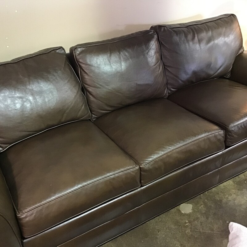 This Ethan Allen Bennett leather three-seat sofa has classic design written all over it.  Featuring luxurious leather, opulent rolled arms and welted loose cushions<br />
<br />
Tailored by hand over a durable engineered wood frame.<br />
<br />
Poly-wrapped high-quality foam and fiber cushions for a supportive seat.<br />
<br />
Removable, tapered legs shown in Raisin, a rich, cool, dark brown water-based finish.<br />
<br />
Matches # 170099<br />
<br />
Dimensions:  87 x 37 x 36