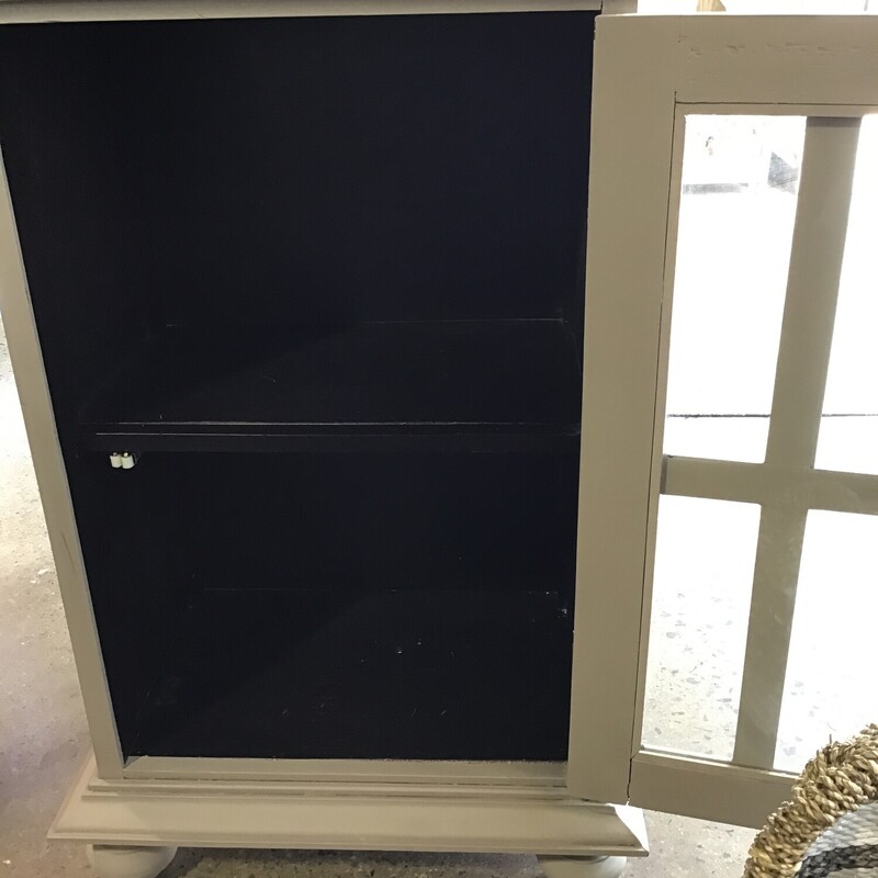 This super neutral cabinet was painted by one of our local artists using Country Chic Driftwood paint and a combination of clear and dark wax. It features a glass door and lower shelf.<br />
Dimensions are 20 in x 13 in x 31 in