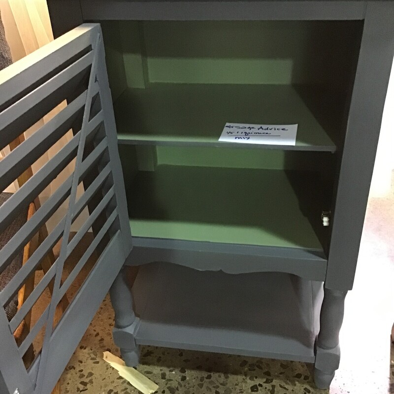 This super functional 1 door cabinet was painted by one of our local artists using a mixture of Country Chic Sage Advice and Liquorice and then clear waxed for protection. It is painted on all 4 sides and features an internal shelf, shutter doors and lower shelf.<br />
Dimensions are 21 in x 14 in x 34 in