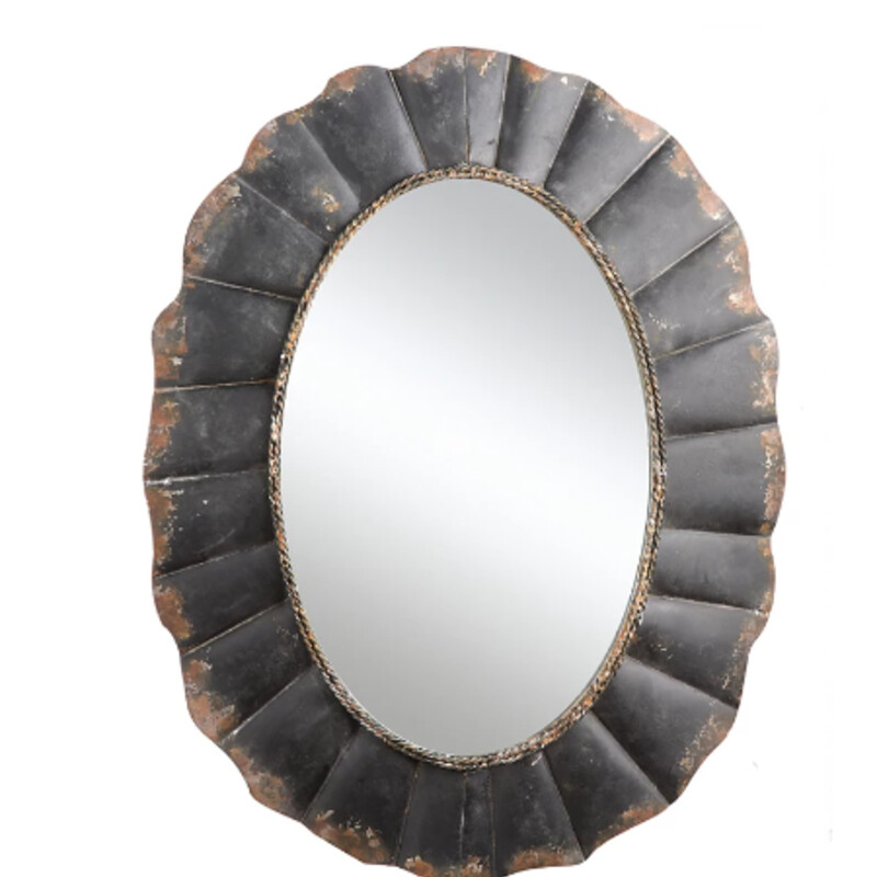 Metal Oval Wavy Mirror
Dark Brown Metal  Size: 24x30H
Watch the light reflect items in your room with this large wall mirror. The metal frame is scalloped with a delicate rope design around the inside edge. This mirror can be the centerpiece of your room decor.
Retail $159