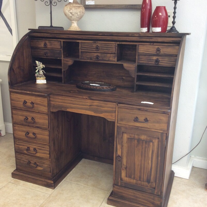 This is a beautiful rustic roll top desk. This desk has 6 mini drawers, 6 standard size drawers, 1 middle drawer, 2 pull out shelfs and a cabinet for your computer.