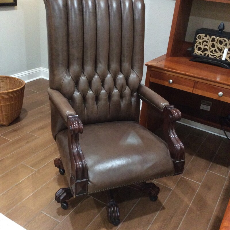 This is a beautiful brown leather Heneredon Desk Chair. The leather is button tufted and has clawfoot legs.