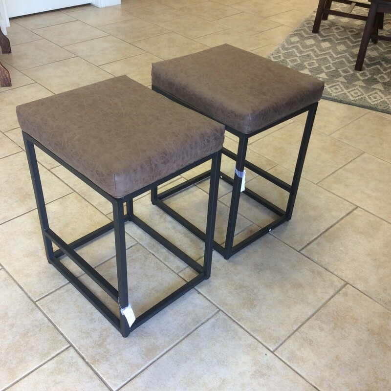 This is a pair of brown faux leather barstools with metal legs.