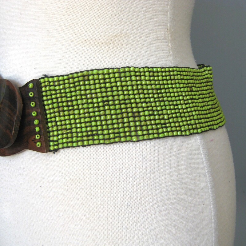 This nice beaded belt has a woodland vibe.  It's a stretch belt in green beads with two wooden hooks as the clasp.<br />
The beads have a natural gradation in color which gives the belt an organ ic dimensional look<br />
Nice and stretchy will fit 28 to about 33 waists.<br />
Appear to have never been worn, the tags are attached.<br />
<br />
Thank you for looking!<br />
#2140