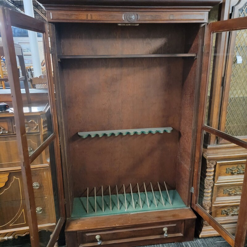 Victorian Gun Cabinet Circa 1880 in good condition.  Has wear consistent with age.  It was probably a Bookcase converted  into a gun cabinet. Measures 76' tall; 48' wide; 17' deep.