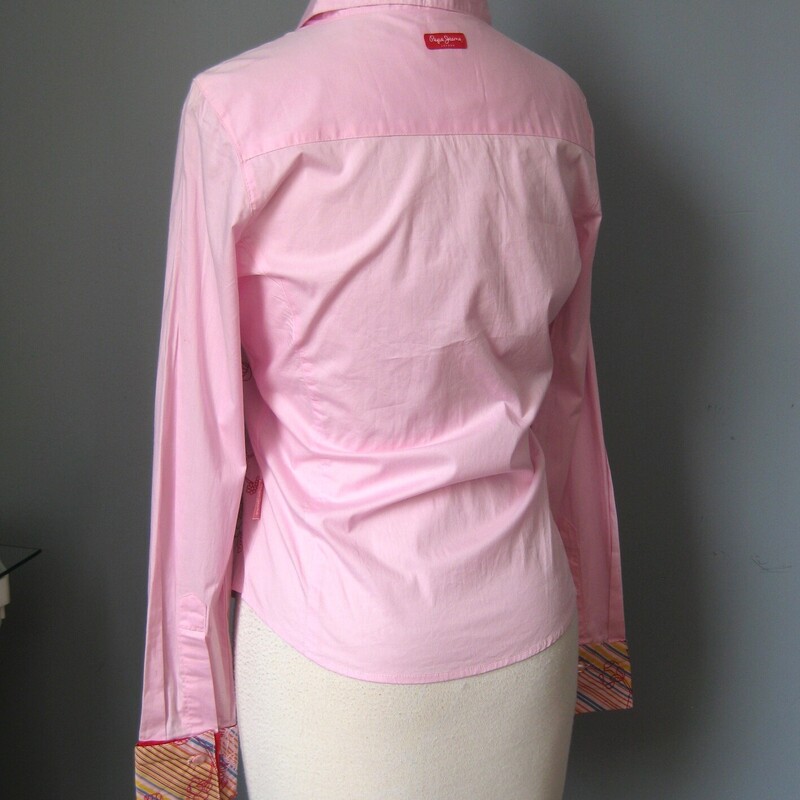 Pink Cotton Shirt with a touch of spandex embroidered with flowers on one side of the front and striped on the other side. the back is plain. The cuffs combine the striped material with the embroidery to pull it all together.<br />
Super cute by Pepe Jeans London<br />
like new condition.<br />
Marked size M, but SMALLER, my mannequin is about a size 4 and it was very snug on her.<br />
here are the flat measurements, use these not the tag to determine if it will fit you.<br />
S-S: 14.25<br />
SL: 18.5<br />
A-A: 18.5<br />
Waist: 16<br />
L: 22.75<br />
Thanks for looking!<br />
#58872