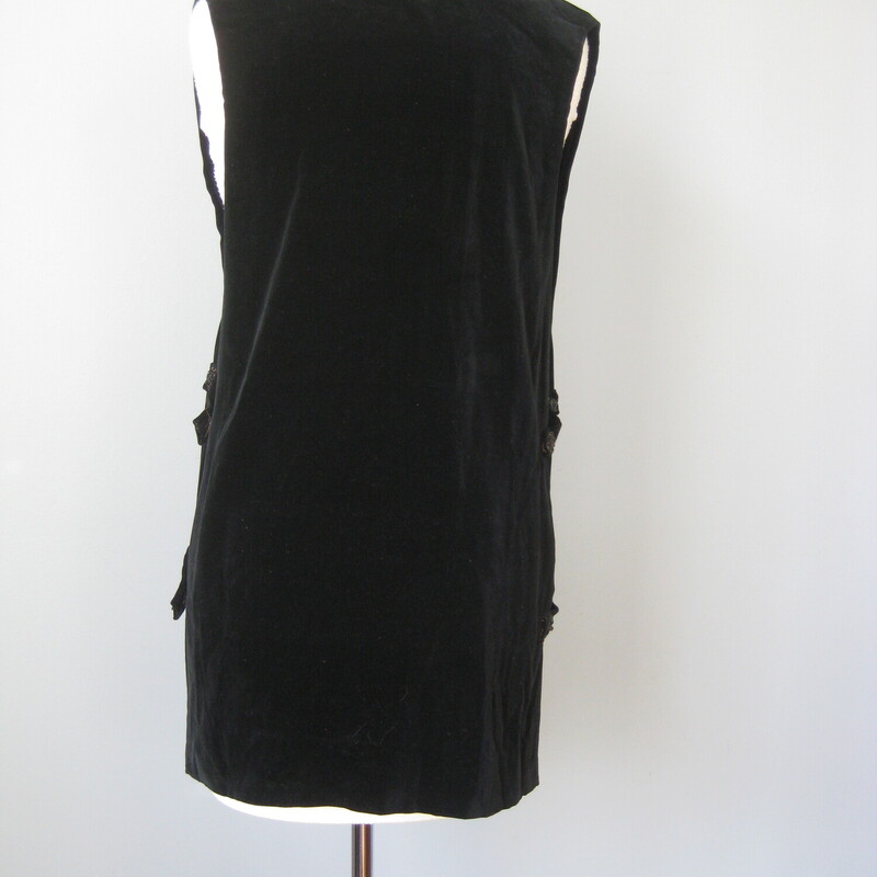 Vtg 20s Velvet Tunic, Black, Size: Small<br />
This an antique black velvet tunic.<br />
It's open on the sides.  The sides are connected by velvet strips terminated in handmade beaded buttons.<br />
On one side the buttons are attached with snaps so you can get in and out more easily.<br />
<br />
The upper check is embroidered with a subtle beaded design.<br />
<br />
unlined<br />
no tags<br />
most likely home made and beautifully finished inside.<br />
amazing condition, fresh and without flaws.<br />
<br />
Here are the flat measurements, please double where appropriate:<br />
<br />
Armpit to armpit: free<br />
Waist : aprox. 20<br />
Length: 20<br />
<br />
<br />
Thanks for looking!<br />
#57375