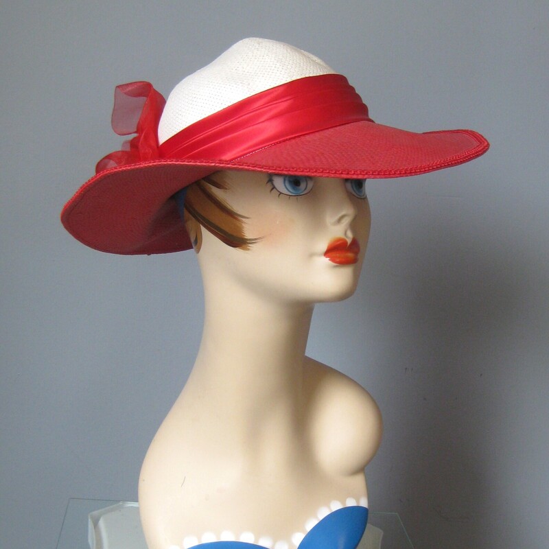 Gorgeous statement hat in red panama with round crown, floral decoration and wide riibon<br />
Perfect for race day, summer weddings and dressing up.The round white crown is surrounded by a red ribbon, finished with a hard red plastic rose.<br />
The red is a bright red and the white is a soft white, not stark.<br />
the inner hat band measures 21.5 around<br />
Excellent condition.  It's been in imperfect storage for a long time and has a tiny amount of lost shape in the crown but this could probably be steamed out easily.<br />
Hat will be shipped carefully packed in a box.<br />
<br />
Thanks for looking!<br />
#3112