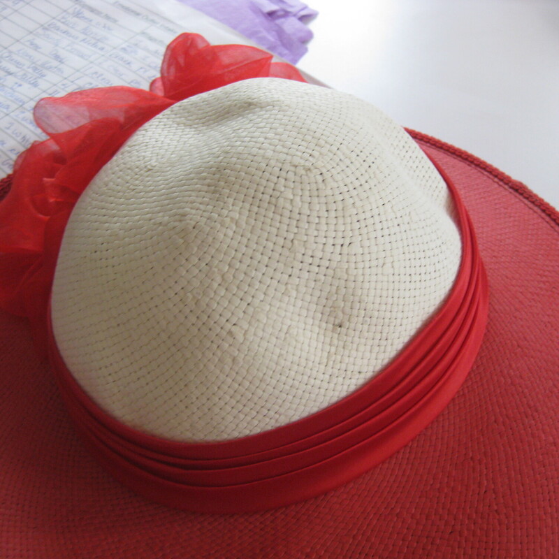 Gorgeous statement hat in red panama with round crown, floral decoration and wide riibon<br />
Perfect for race day, summer weddings and dressing up.The round white crown is surrounded by a red ribbon, finished with a hard red plastic rose.<br />
The red is a bright red and the white is a soft white, not stark.<br />
the inner hat band measures 21.5 around<br />
Excellent condition.  It's been in imperfect storage for a long time and has a tiny amount of lost shape in the crown but this could probably be steamed out easily.<br />
Hat will be shipped carefully packed in a box.<br />
<br />
Thanks for looking!<br />
#3112