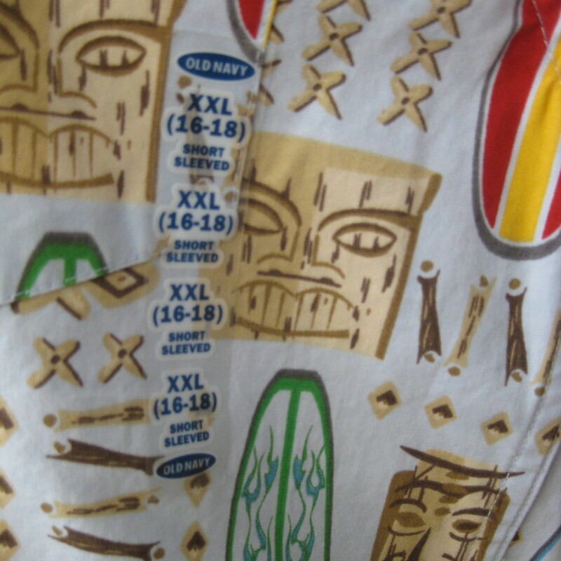 Old Navy Tiki SS Bttndwn, Blue, Size: BOYS 2x
Very cool tiki print featuring surf boards and polynesian masks on an aqua blue background.
Sturdy cotton with short sleeves.
It's new, never worn.

Marked size XXL
Flat measurements:
shoulder to shoulder: 19
armpit to armpit: 20
width at hem: 20
length: 28.75

This would fit a girl too, but it's a bit slim in the bust area for anyone with a bust,  it barely buttons around my mannequin which is about a womans size four.

Thanks for looking!
#4158