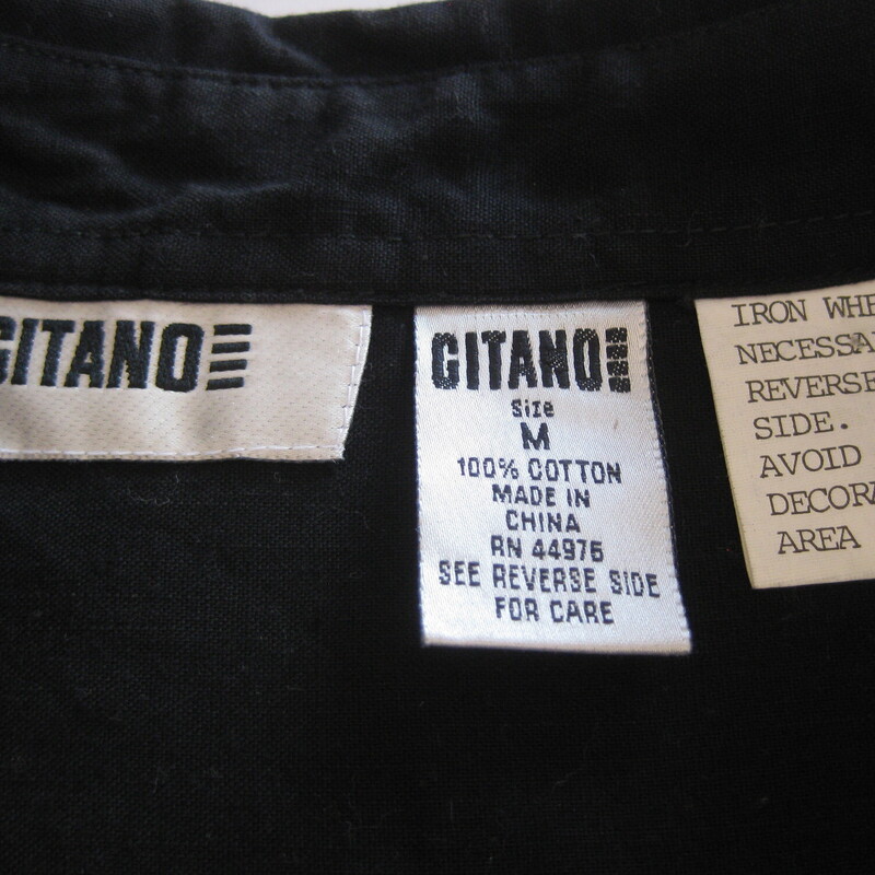Here's a black western shirt with silver and white embroidery on the uppers chest. It's by Gitano which was a cool kid brand in the 80s.<br />
Buttons<br />
big shoulder pads<br />
<br />
Here are the flat measurements, please double where appropriate:<br />
shoulder to shoulder: 20<br />
armpit to armpit: 24.5<br />
underarm sleeUnderarm sleeve seam length: 18<br />
<br />
Great condition.<br />
<br />
Thanks for looking.<br />
#57994