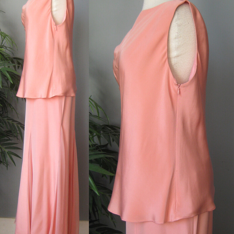 Elegantly draped ensemble is a 2 pc by Flores and Flores.<br />
Lustrous 100% silk in a soft peach color.<br />
1. A high cowl neck tunic, sleeveless, with a decorative cord tie at one shoulder.  Fully lined, side zipper.  Flares out slightly at the hem.<br />
flat measurements:<br />
armpit to armpit: 24<br />
waist area: 18<br />
width at hem: 22.5<br />
length: 23.5<br />
2. long gored skirt, same material but the gores are filled with tonal sheer silk chiffon Fully lined, zipper closure.<br />
Flat measurements:<br />
waist: 17<br />
hip: 23<br />
length: 42<br />
<br />
CONDITION:  two tiny issues:<br />
1.  a one inch long white dash of deoderant.  I don't DARE try to get it out, honestly in person in regular lighting - hard to see.  Located on the center front over the ribs.  See it in my first picture<br />
2. a barely there mar in the silk on the back of the skirt near the wearer's backside.  See it in my last picture<br />
Thanks for looking!<br />
#3683